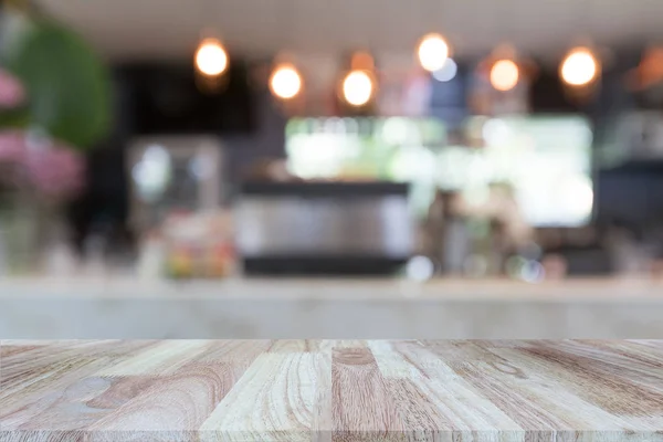 Wooden tabletop on blurred restaurant or coffee shop background, can be used for display or montage your products