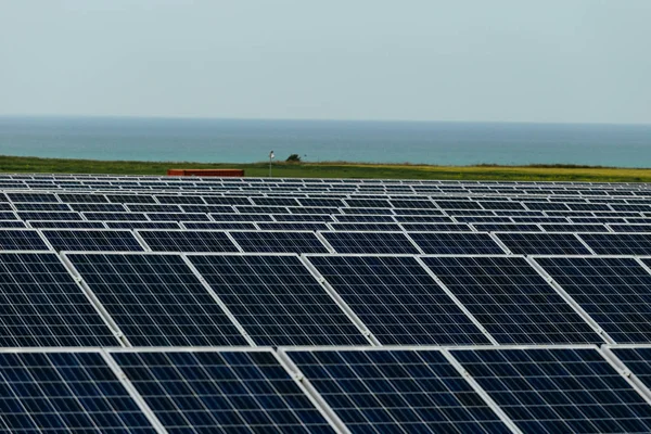 Solar panels on a cloudy day in Normandy, France. Solar energy, modern electric power production technology, renewable energy concept. Environmentally friendly electricity production Stock Photo