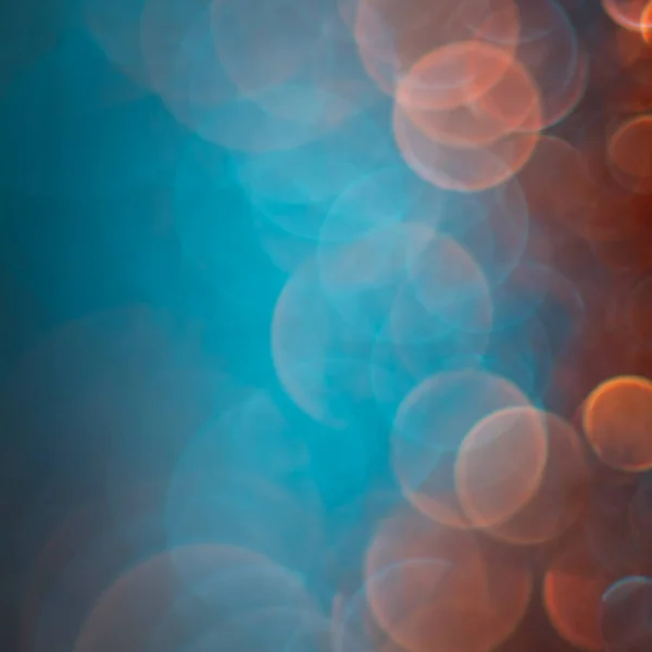 Abstração bokeh laranja sobre um fundo azul. Desfocado . — Fotografia de Stock