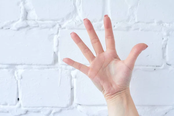 Hand gesture isolated on white brick wall background. — Stock Photo, Image