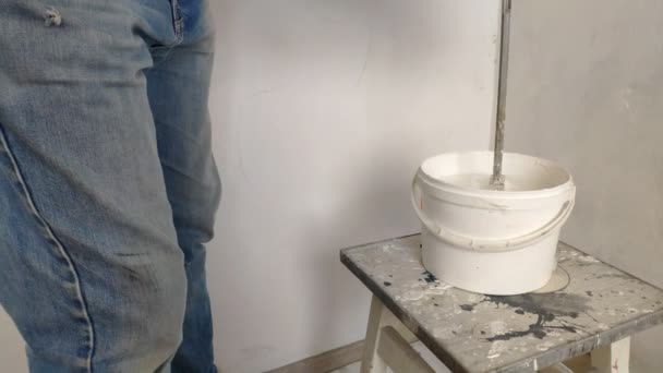 Gray Haired Bearded Man Mixes White Paint Bucket Stick Pours — Stock Video