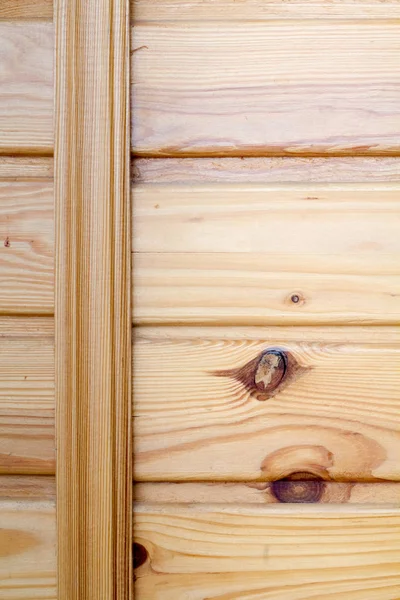 Closeup of wooden boards fastened by a cross bar, the theme of environmental friendliness.