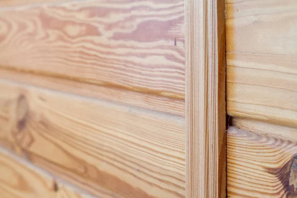 Closeup of wooden boards fastened by a cross bar, the theme of environmental friendliness.