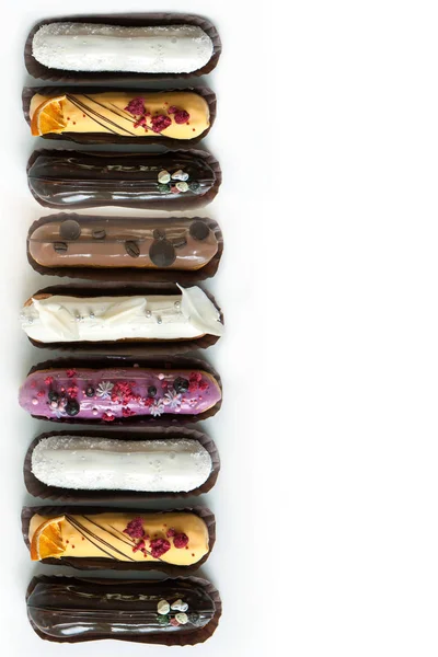 Set of several eclairs with various fillings and design isolate on a white background, the concept of French cuisine — Stock Photo, Image