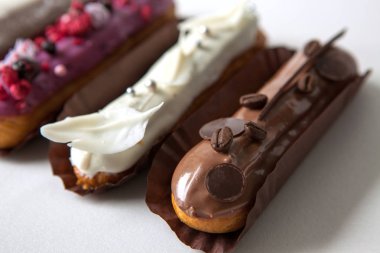 Çeşitli dolgular ve tasarım beyaz bir arka planda izole çeşitli Eclairs seti, Fransız mutfağı kavramı