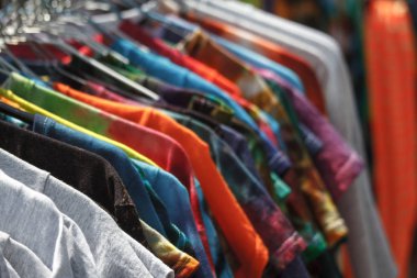 Sokakta askıları asılı çok renkli T-shirt yakın çekim, adil, ikinci el, geri dönüşüm konsepti