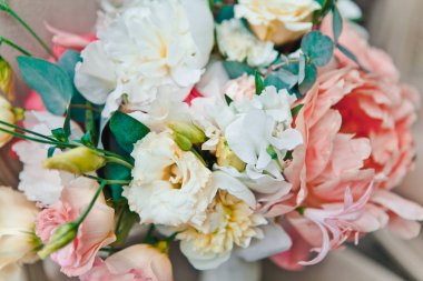 Close-up bridal bouquet of fresh spring and summer flowers in pastel colors stand on a classic chair, selective focus clipart
