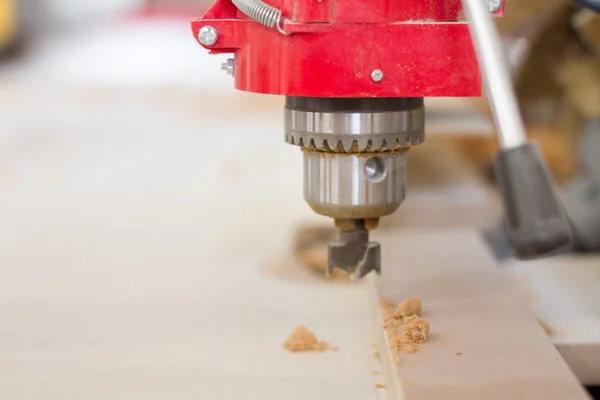 Closeup of the head of the drilling machine with nozzle in the furniture workshop, selective focus — Stock Photo, Image