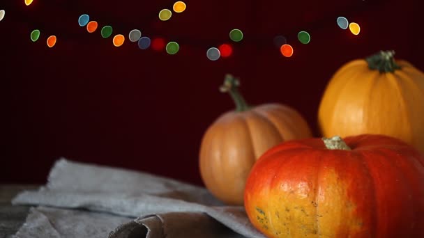 Autumn Background Dark Wooden Surface Three Pumpkins Background Blurry Lights — Stock Video