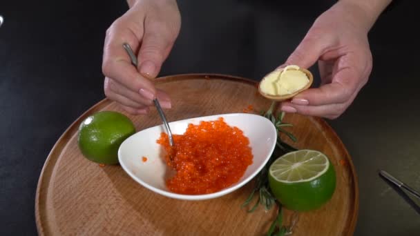 Red caviar is put into the waffle tartlet. slow motion — Stock Footage Red caviar is put into the waffle tartlet. slow motion Royalty Free Stock Footage