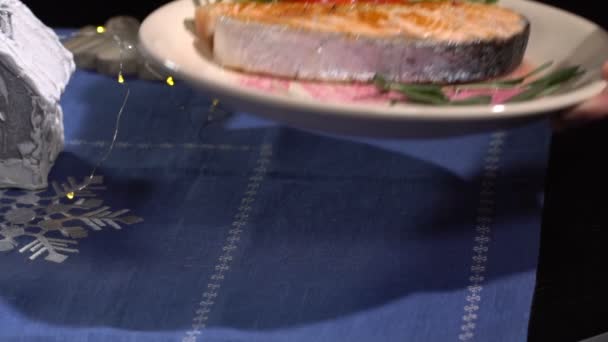 Dish with salmon put on the table. Slow motion — Stock Footage Dish with salmon put on the table. Slow motion Stock Footage