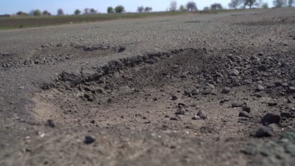 Cars drive along the road with potholes — Stock Video