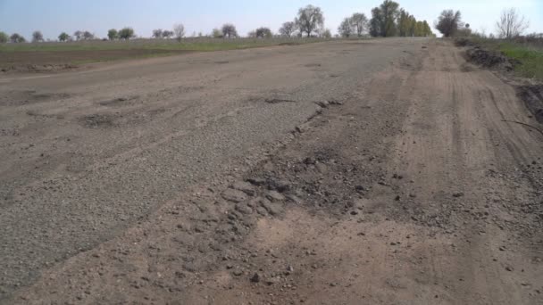 Old asphalt road with potholes — Stock Video