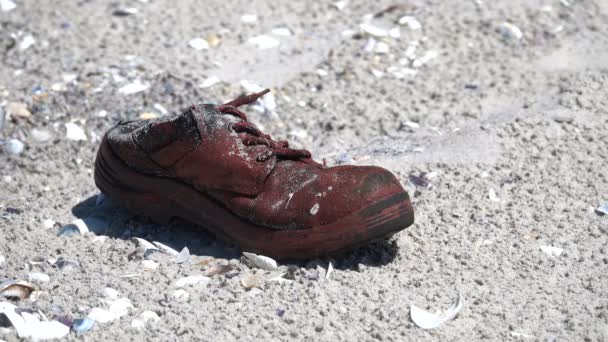 Stará bota na písčitém pobřeží — Stock video