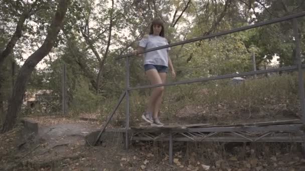 Fille traverse un vieux pont — Video