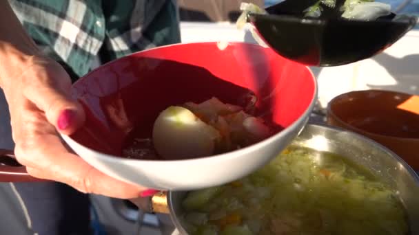 Cook on a yacht serves soup. Slow motion — ストック動画