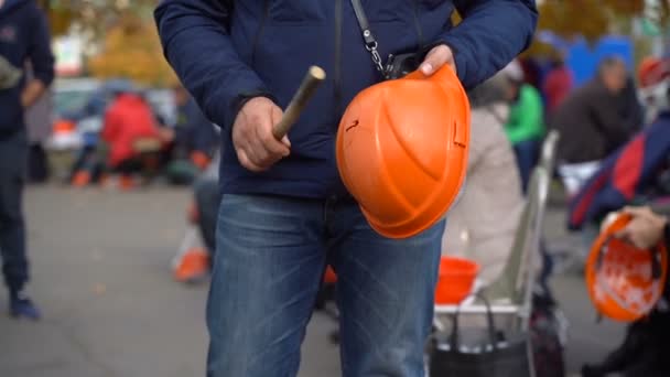 Demonstranten raken de helm met stokjes — Stockvideo