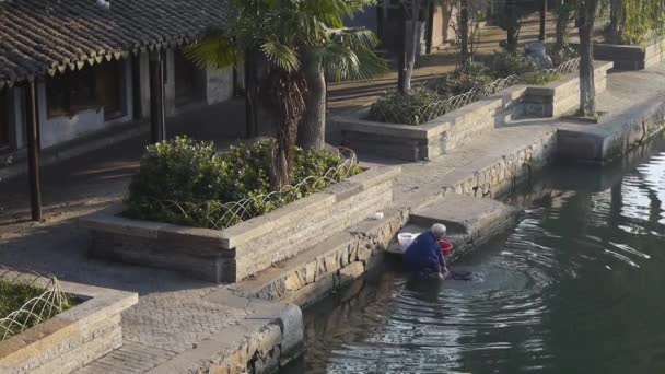 Paños de lavado humanos en el río, casas chinas tradicionales, XiTang Water Town, china . — Vídeos de Stock