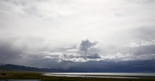 4k masa de nubes rodando sobre el lago Tíbet namtso, tienda de pastores, un grupo de vacas . — Vídeos de Stock