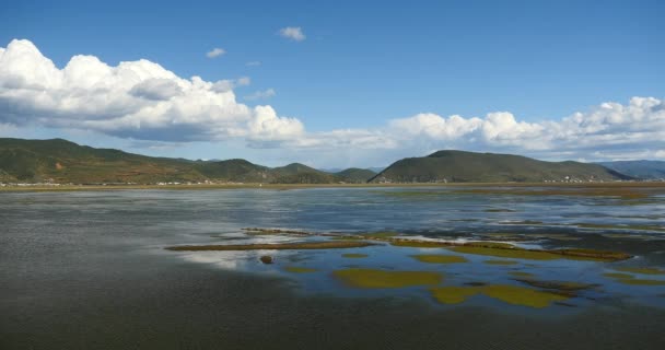 4k nubes masa rodando sobre las montañas reflejan en el lago, Shangri-La yunnan, china . — Vídeo de stock