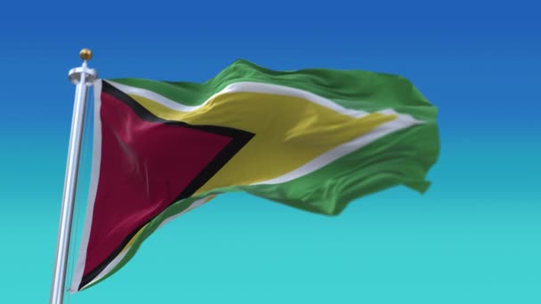 4k Guyana Nationale vlag rimpels lus naadloze wind in blauwe lucht achtergrond. — Stockvideo