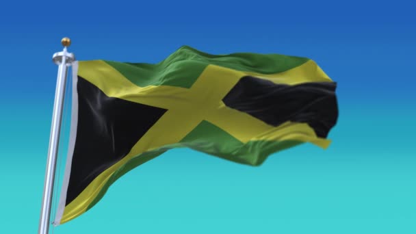 4k Jamaica Nationale vlag rimpels lus naadloze wind in blauwe lucht achtergrond. — Stockvideo