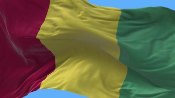 4k Γουινέα εθνική σημαία ρυτίδες κυματίζει τον ουρανό αέρα αδιάλειπτη βρόχο φόντο. — Αρχείο Βίντεο