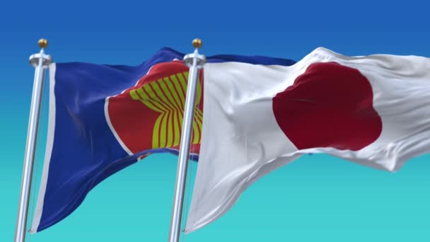 4k Zökkenőmentes Japán és az ASEAN zászlók kék ég háttér, JP. — Stock videók