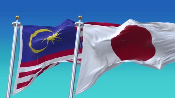 4k Płynne flagi Japonii i Malezji z niebieskim tle nieba, JP. — Wideo stockowe