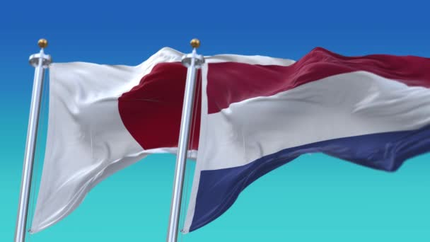 4k Bandeiras sem emenda do Japão e Holanda com fundo azul do céu, JP . — Vídeo de Stock