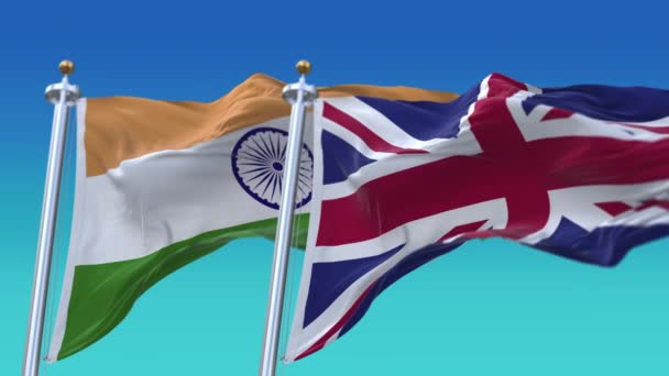 4k Płynne Indie i Wielka Brytania Anglia Zjednoczone Królestwo Flagi z błękitnym tle nieba — Wideo stockowe