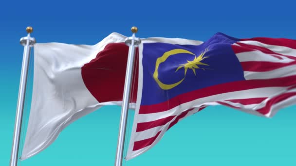 4k Płynne flagi Japonii i Malezji z niebieskim tle nieba, JP. — Wideo stockowe
