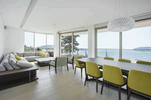 Interior of light spacious living room with large panoramic windows in a luxury villa