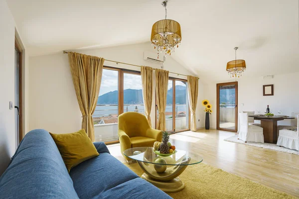 Interior of light spacious living room with served table and dining area in a luxury villa