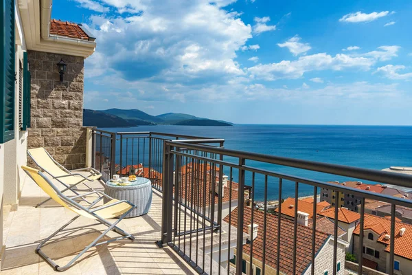 Spacious terrace in the villa with sea view. The terrace offers view on the roofs of the elite village houses and the marina with moored luxury yachts and boats