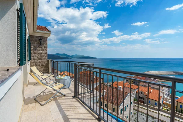 Spacious terrace in the villa with sea view. The terrace offers view on the roofs of the elite village houses and the marina with moored luxury yachts and boats