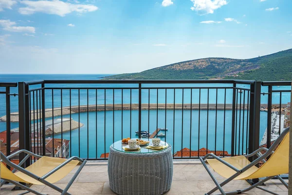 Spacious terrace in the villa with sea view. The terrace offers view on the roofs of the elite village houses and the marina with moored luxury yachts and boats