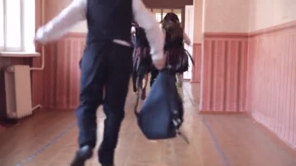 Een groep kinderen loopt langs de corridor in de school — Stockvideo