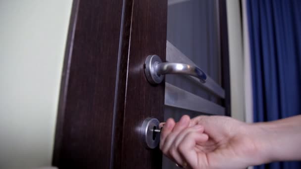 Opening or locking a door lock with a key by woman — Stock Video