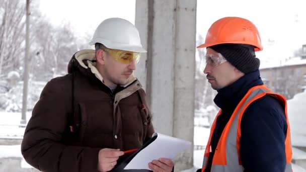 Der Kunde, ein Geschäftsmann, bespricht mit dem Architekten und Ingenieur den Bau seines neuen Einkaufszentrums. Plan, Arbeit — Stockvideo