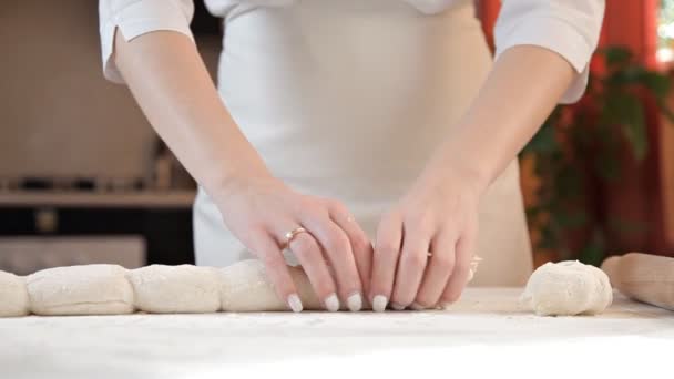 The girl makes a form of raskatany dough for baking — Stock Video