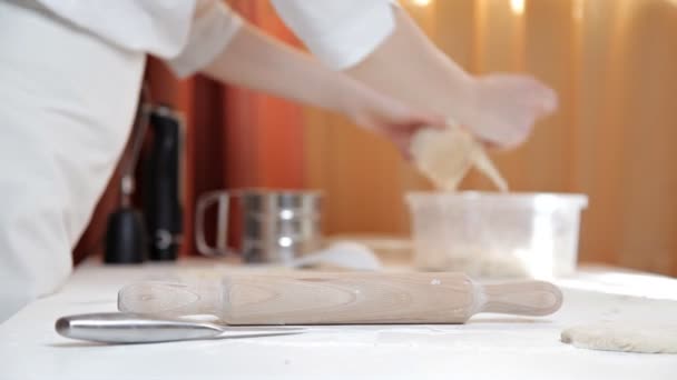 Mädchen in einer Schürze bereitet rohen Pizzateig zu. Das Mädchen bereitet zu Hause eine leckere Pizza zu. Gebäck — Stockvideo