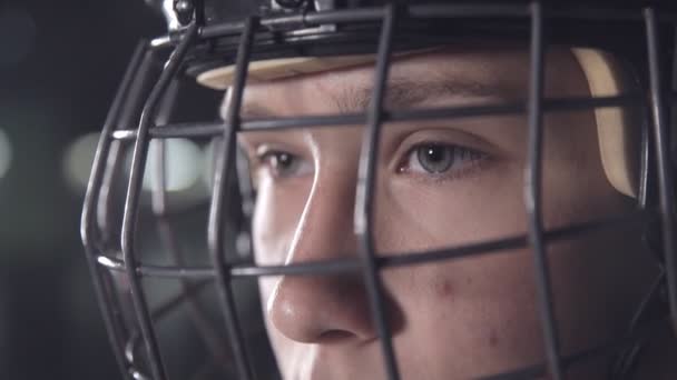 Handsome hockey player. dark arena, close up portrait of defender or forward canadian player — Stock Video