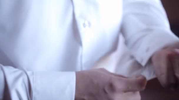 Elegant man buttoning the cuffs of his shirt — Stock Video