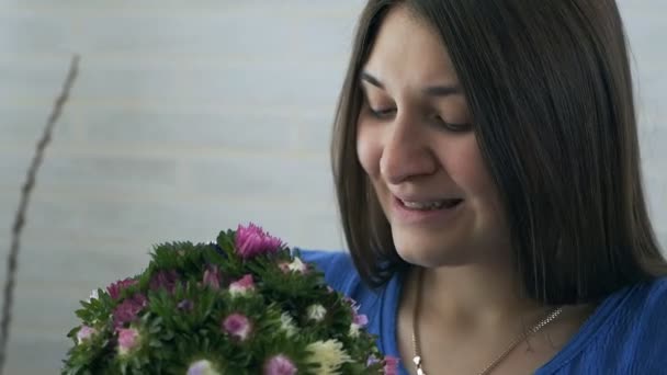 Egy fiatal terhes nő szippantás egy virág, és allergiás — Stock videók