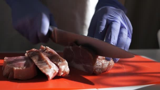 Cocine cortando una carne con un cuchillo. Manos cortando carne fresca Close-Up. Cortar carne fresca en filetes. Movimiento lento — Vídeos de Stock