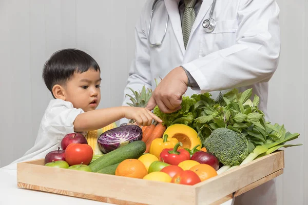 Healthy and nutrition concept. Kid learning about nutrition with doctor to choose eating fresh fruits and vegetables.