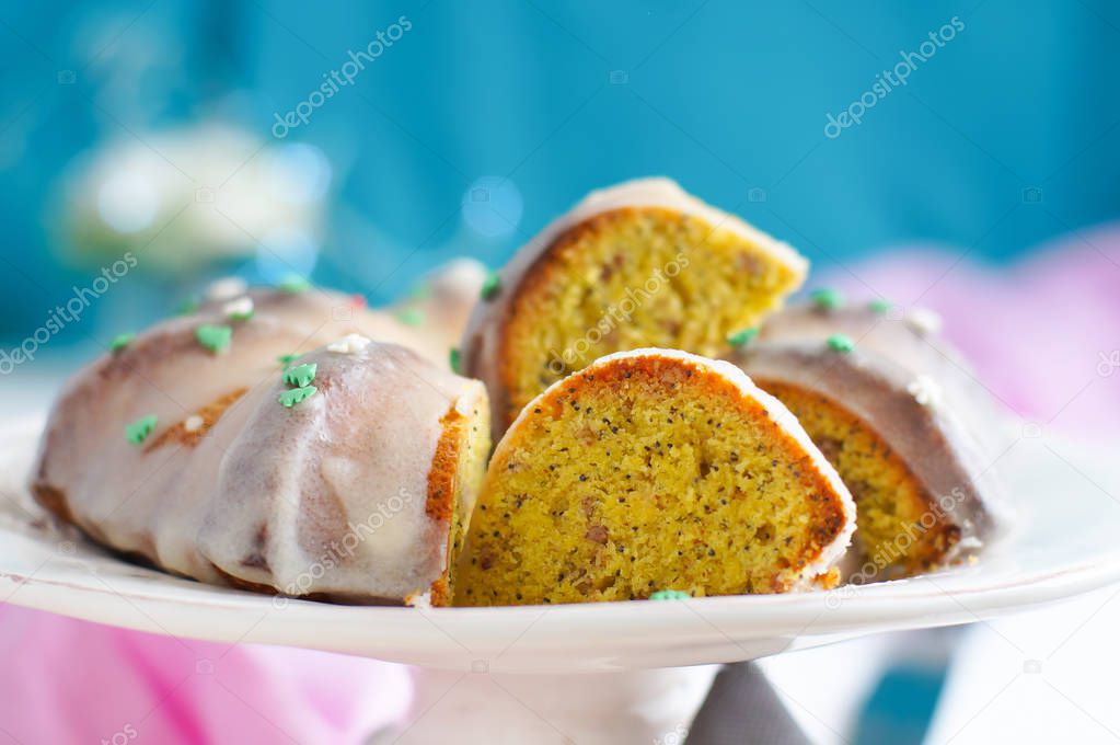 Homemade Holiday Cake. Cooked with turmeric, nuts, and poppy seeds. Decorated with white icing.