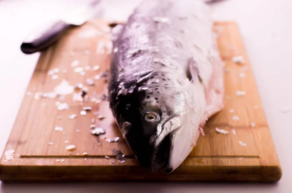 Raw fresh salmon on wooden cutting board — Stock Photo, Image