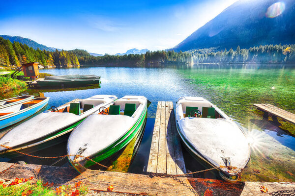 Fantastic autumn morning at Hintersee lake. Few boats on the lake with turquoise water of Hintersee lake. Location: resort Ramsau, National park Berchtesgadener Land, Upper Bavaria, Germany Alps, EuropeBerchtesgadener Land, Upper Bavaria, Germany Alp
